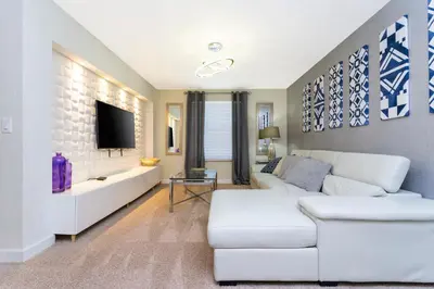 a living room with a white couch and a tv at Rare!Lake Front Pool-Spa, Close To Clubhouse-1691C in Kissimmee