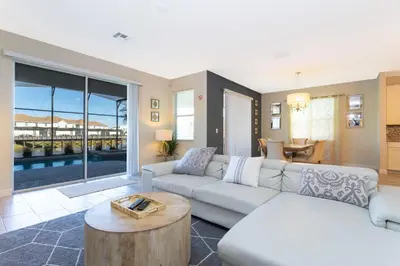 a living room with a couch and a table at Rare!Lake Front Pool-Spa, Close To Clubhouse-1691C in Kissimmee