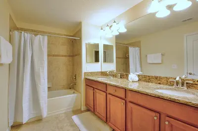 a bathroom with two sinks and a tub and a shower at Paradise Palms-5 Bed Townhome Wsplashpool-3045Pp in Kissimmee