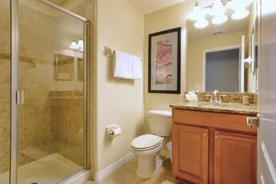 a bathroom with a shower and a toilet and a sink at Paradise Palms-5 Bed Townhome Wsplashpool-3045Pp in Kissimmee