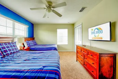 a bedroom with two beds and a ceiling fan at Bright Cheery Vacation Villa-1638St in Kissimmee
