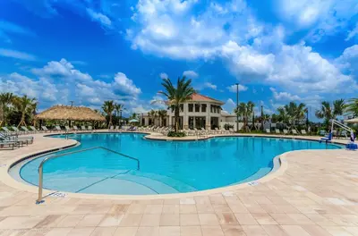 a swimming pool at a resort with palm trees at Bright Cheery Vacation Villa-1638St in Kissimmee