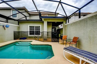 a swimming pool in the backyard of a house at Bright Cheery Vacation Villa-1638St in Kissimmee