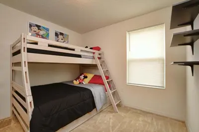a bedroom with two bunk beds and a window at Charming Waterfront Townhome - 1954Cy in Kissimmee