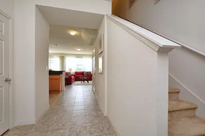 a hallway with a staircase in a house at Charming Waterfront Townhome - 1954Cy in Kissimmee