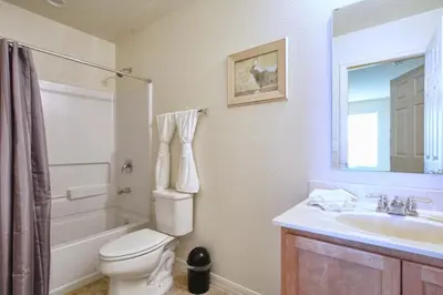 a bathroom with a toilet and a sink and a shower at Charming Waterfront Townhome - 1954Cy in Kissimmee
