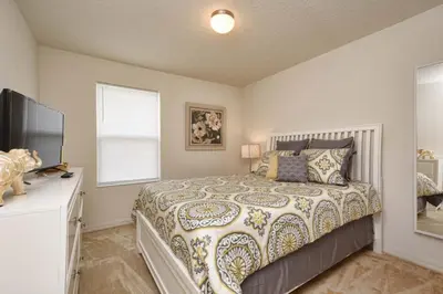 a bedroom with a bed and a television in it at Charming Waterfront Townhome - 1954Cy in Kissimmee