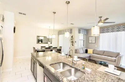 a kitchen with a sink and a living room at Family Retreat W-Splashpool-1637St in Kissimmee