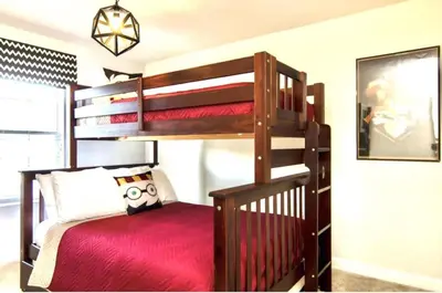 a bedroom with a bunk bed with a red mattress at Family Retreat W-Splashpool-1637St in Kissimmee