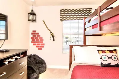 a bedroom with a bed with a wooden headboard at Family Retreat W-Splashpool-1637St in Kissimmee