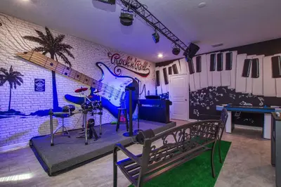 a room with a wall with a mural of a guitar at Storey Lake 8 Bed Lake Front Pool Spa - 1684Str in Kissimmee