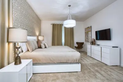 a bedroom with a large bed and a tv at Sonoma - 6 Bedroom Pool Home- 1859Snr in Kissimmee