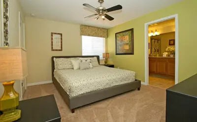 a bedroom with a bed and a ceiling fan at Paradise Palms- 5 Bed Townhome Wsplashpool-3020Pp in Kissimmee
