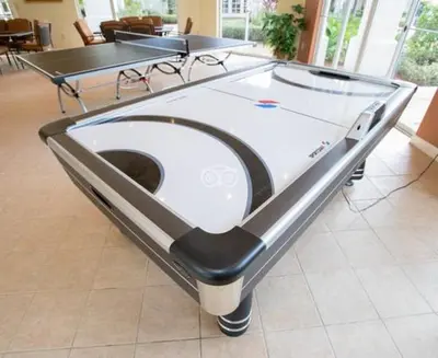 a ping pong table in a room with two tables at Harry's Hangout at Legacy Dunes - Sage Vacations in Kissimmee