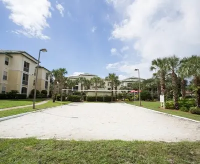 an empty parking lot in front of a building at Harry's Hangout at Legacy Dunes - Sage Vacations in Kissimmee