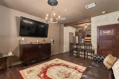 a living room with a couch and a flat screen tv at Harry's Hangout at Legacy Dunes - Sage Vacations in Kissimmee