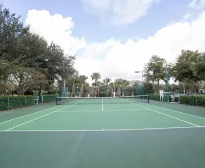 a tennis court with a tennis racket on it at Harry's Hangout at Legacy Dunes - Sage Vacations in Kissimmee