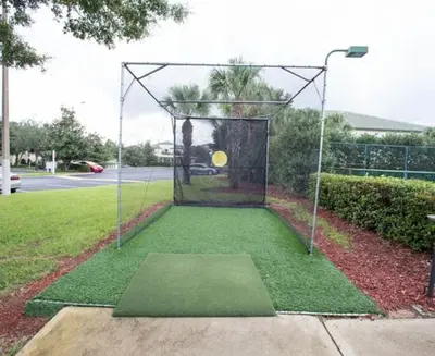 a batting cage with a frisbee on it at Harry's Hangout at Legacy Dunes - Sage Vacations in Kissimmee