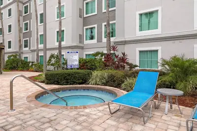 a patio with a chair and a table and a building at Apartment w 4 Beds Near I-Drive in Orlando