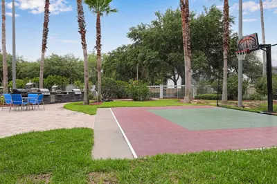 a basketball hoop in a park with palm trees at Apartment w 4 Beds Near I-Drive in Orlando