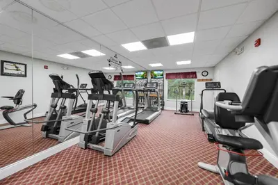 a gym with treadmills and elliptical machines at Apartment w 4 Beds Near I-Drive in Orlando