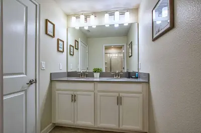 a bathroom with a sink and a mirror at Modern Decor, Waterview With Splashpool, Bbq 1636Str in Kissimmee