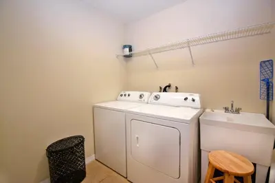 a laundry room with a washing machine and a sink at Family Friendly Home W Game Room 1705Vp in Kissimmee