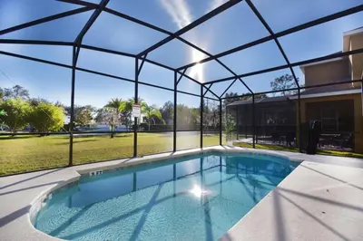 an indoor swimming pool with a large glass enclosure at Family Friendly Home W Game Room 1705Vp in Kissimmee
