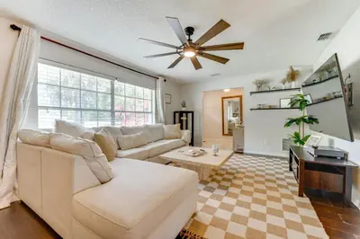 a living room with a couch and a ceiling fan at Private Outdoor Oasis with Pool Home in Longwood! in Orlando