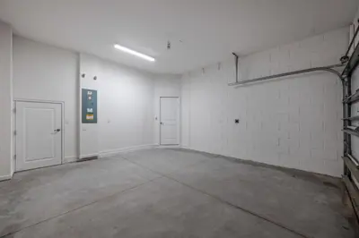 an empty room with white walls and two white doors at Modernparadiso Grande5Bedspool in Orlando