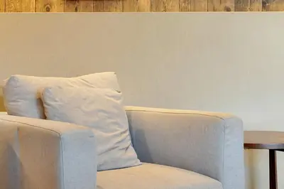 a white chair with a pillow next to a table at Magic Village Resort 5 Minutes to Disney!! in Orlando