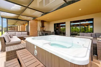 a large tub in a room with a patio at Magic Village Resort 5 Minutes to Disney!! in Orlando