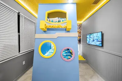 a room with a yellow bunk bed and two mirrors at Cozy Apartment 03 Bedrooms at Storey Lake Resort in Kissimmee