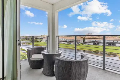 a balcony with chairs and a view of a field at Cozy Apartment 03 Bedrooms at Storey Lake Resort in Kissimmee