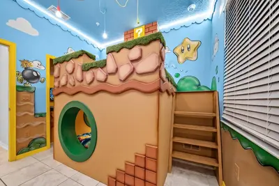 a play room with a gingerbread house mural at Cozy Apartment 03 Bedrooms at Storey Lake Resort in Kissimmee