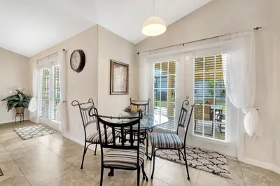 a dining room with a table and chairs at Anthea's Disney Vacation Home in Orlando