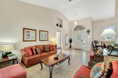 a living room with a couch and a table at Anthea's Disney Vacation Home in Orlando