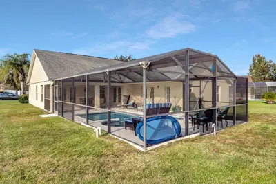 a large house with a pool in the backyard at Anthea's Disney Vacation Home in Orlando