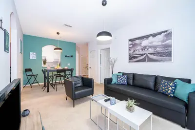 a living room with a couch and a table at Beautiful Resort 3 Bedrooms Condo Near Disney in Kissimmee