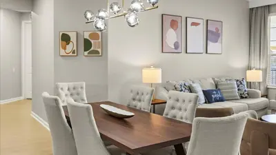 a dining room with a table and chairs and a couch at Upstay Spacious 3BR Home w Patio Vista Cay Resort in Orlando