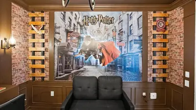 a room with a large movie poster on the wall at Upstay Spacious 3BR Home w Patio Vista Cay Resort in Orlando