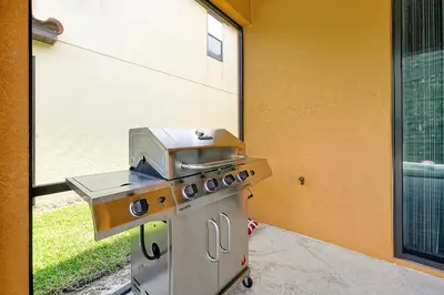 a barbecue grill sitting outside of a building at Disney Dream at Veranda Palms Resort in Kissimmee