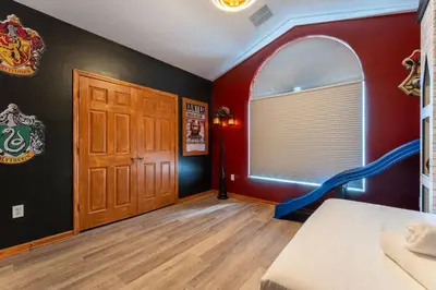 a room with a bed and a window and a door at *Sun Palm Paradise* | Sleeps 14 | Near Disney! in Kissimmee