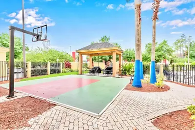 a basketball court with a gazebo and a basketball hoop at Chic Apartment near Disney w Pool Hot Tub Arcade in Orlando