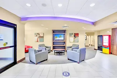 a waiting room at a hospital with chairs and tables at Chic Apartment near Disney w Pool Hot Tub Arcade in Orlando