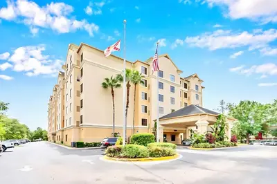 a hotel with a flag on top of it at Chic Apartment near Disney w Pool Hot Tub Arcade in Orlando