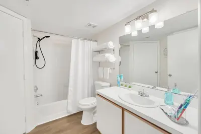 a white bathroom with a sink and a toilet at Elegant and cozy 2 BD condo near Disney in Kissimmee