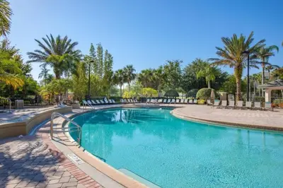 a swimming pool in a resort with palm trees at 3 Bedrooms 35 Bathrooms Vista Cay 4845-148 in Orlando