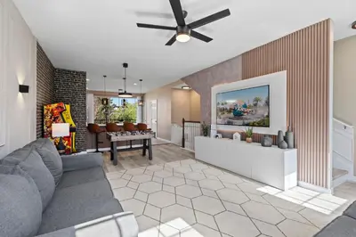 a living room with a couch and a ceiling fan at 3 Bedrooms 35 Bathrooms Vista Cay 4845-148 in Orlando