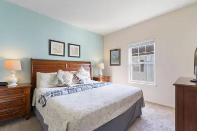 a bedroom with a large bed and a window at Outstanding 4 bdr near Disney 16108 in Kissimmee